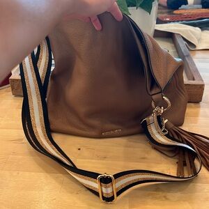 Michael Kors bag with striped strap from a boutique. Used condition.